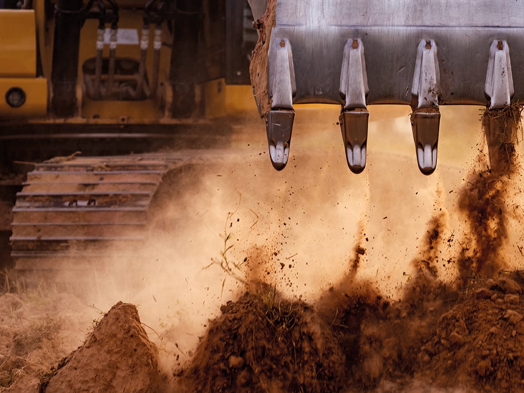 Backhoe,Working,By,Digging,Soil,At,Construction,Site.,Bucket,Teeth