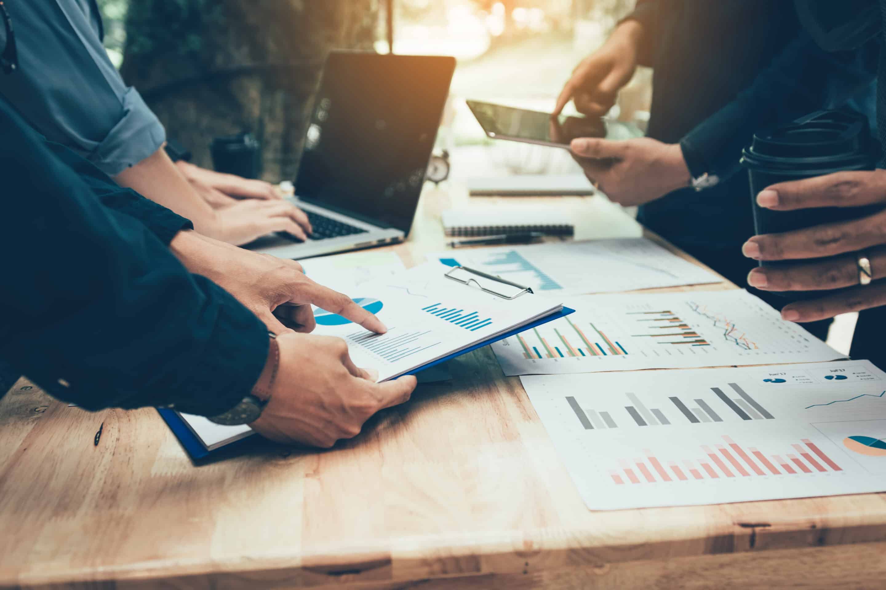 Teamwork,With,Business,People,Analysis,Cost,Graph,On,Desk,At